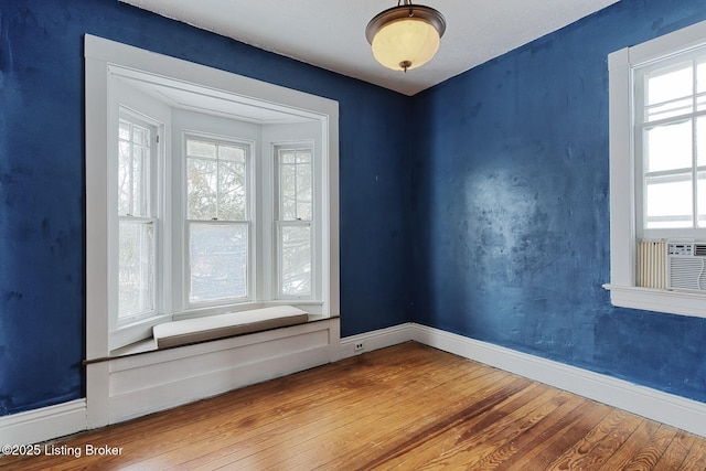 empty room featuring wood finished floors and baseboards