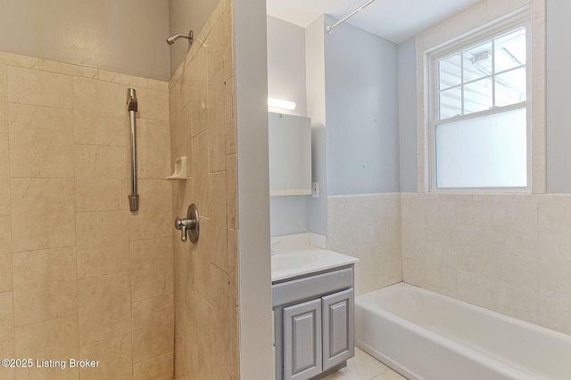 bathroom with a bathing tub, tiled shower, and vanity