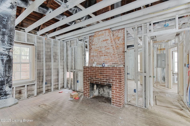 unfurnished living room featuring a brick fireplace