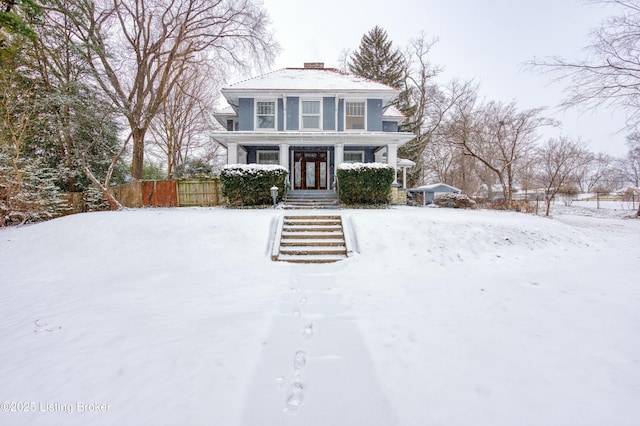 view of front of home featuring fence and a chimney