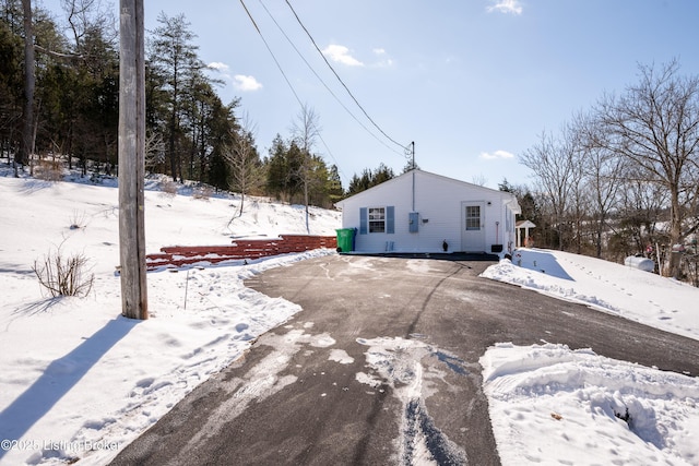 view of snow covered rear of property