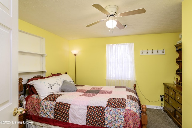 carpeted bedroom featuring a textured ceiling and ceiling fan