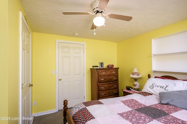 carpeted bedroom with a textured ceiling and a ceiling fan