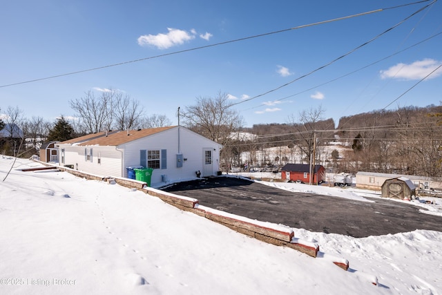 exterior space with an outbuilding and a storage shed