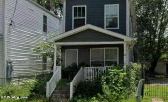 view of front of house featuring covered porch and fence private yard