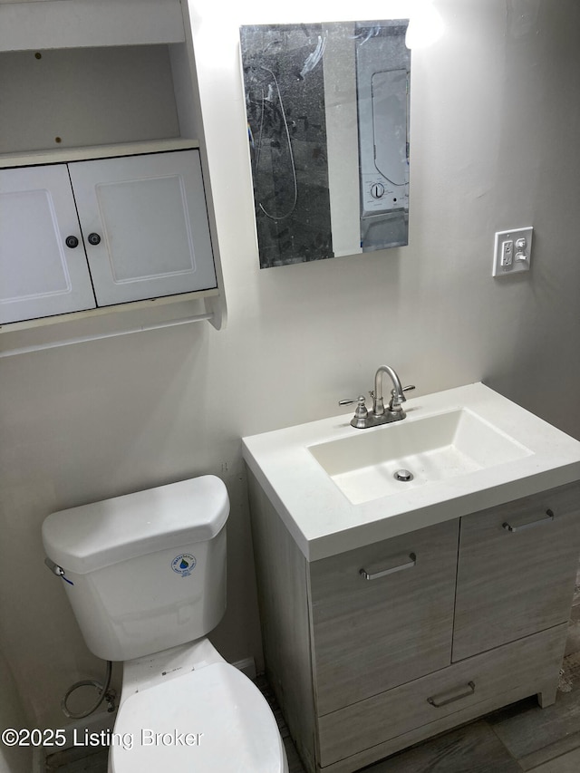 bathroom with toilet and vanity