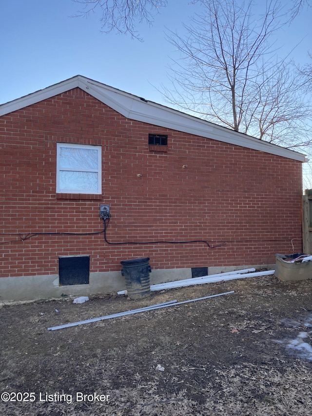 view of side of home with brick siding