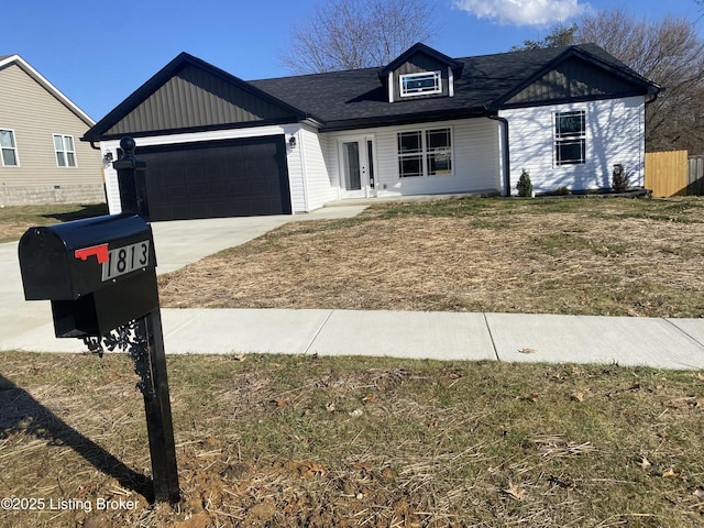 view of front of home with driveway, a garage, and a front yard