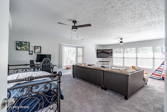 interior space featuring a textured ceiling, a ceiling fan, and baseboards