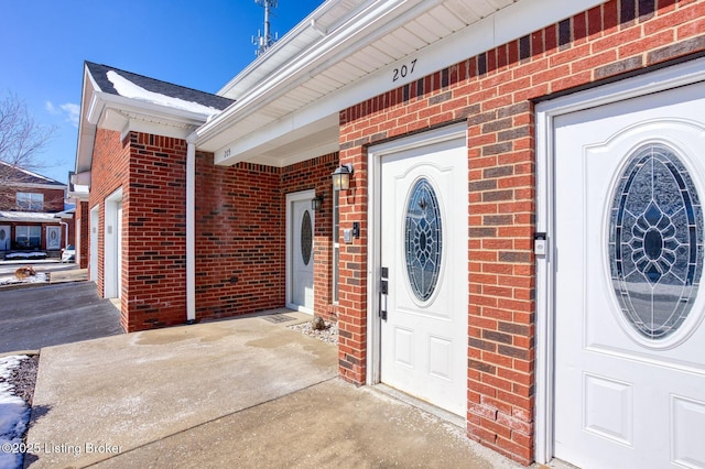 property entrance featuring brick siding