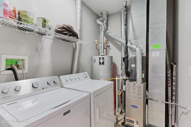 washroom featuring heating unit, laundry area, water heater, and independent washer and dryer