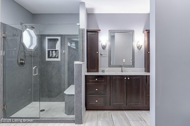 bathroom featuring a stall shower and vanity