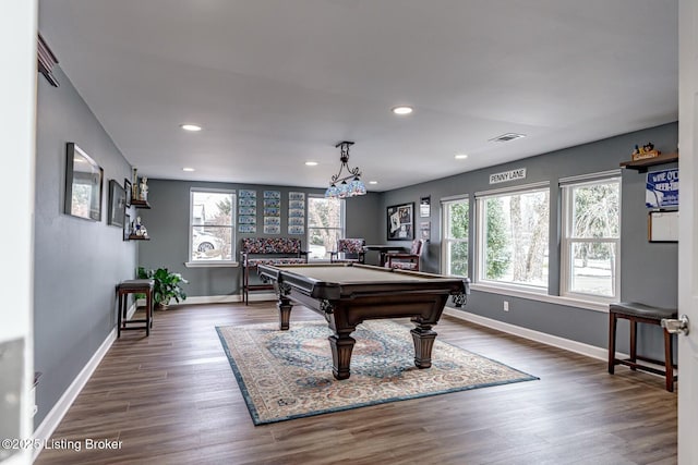 game room featuring dark wood-type flooring, a wealth of natural light, visible vents, and baseboards