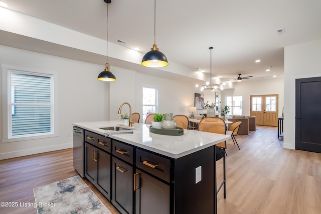 kitchen with visible vents, light wood-style flooring, dishwasher, and a sink