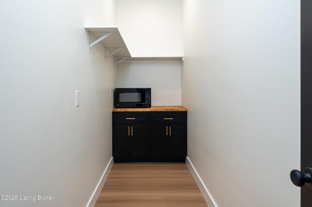 interior space featuring light wood finished floors and baseboards