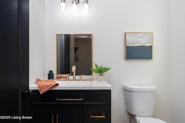 bathroom featuring toilet and vanity