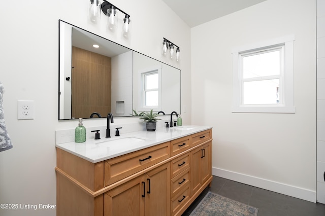 full bathroom featuring double vanity, tile patterned floors, baseboards, and a sink