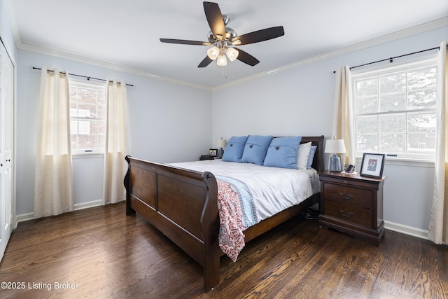 bedroom featuring baseboards, multiple windows, dark wood-style flooring, and crown molding