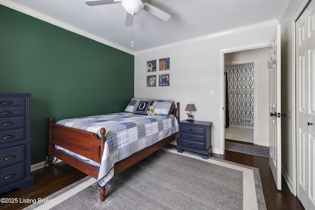 bedroom featuring dark wood-type flooring, ornamental molding, and baseboards