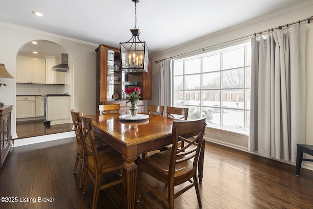 dining space featuring recessed lighting, arched walkways, dark wood-style flooring, and ornamental molding