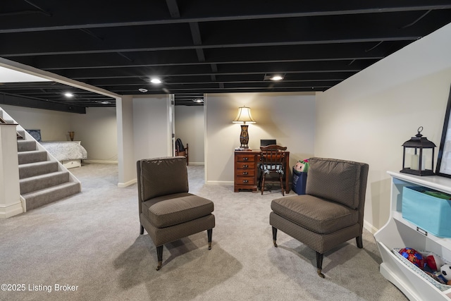 sitting room featuring stairs, carpet, and baseboards