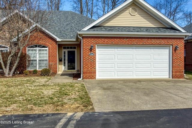 single story home featuring a garage, brick siding, concrete driveway, roof with shingles, and a front yard