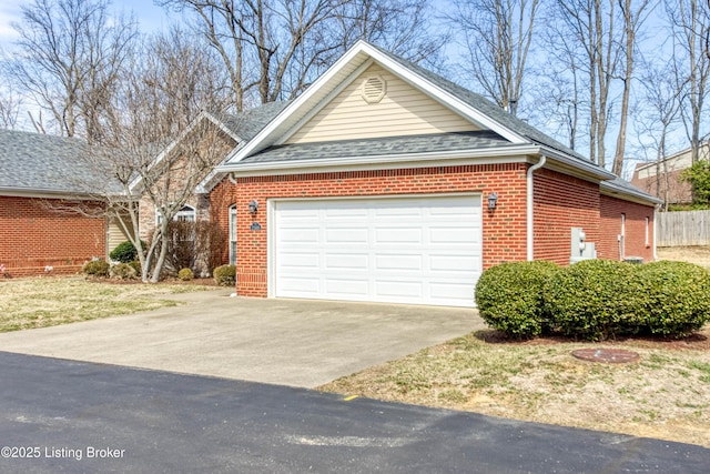 view of home's exterior featuring concrete driveway, brick siding, an attached garage, and roof with shingles