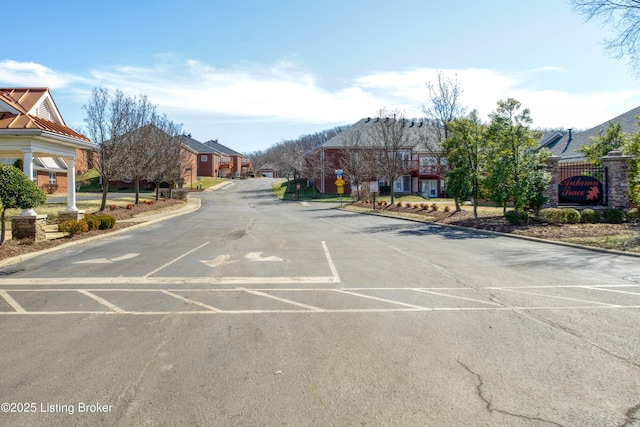 view of road with a residential view and curbs