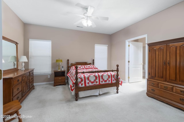 bedroom featuring baseboards, visible vents, a ceiling fan, and light colored carpet