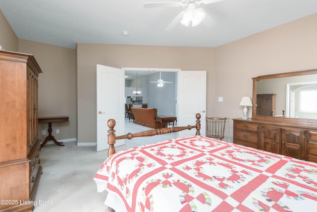 bedroom featuring baseboards, a ceiling fan, and light colored carpet