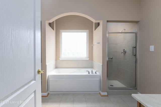 full bathroom with a stall shower, tile patterned flooring, a garden tub, and vanity