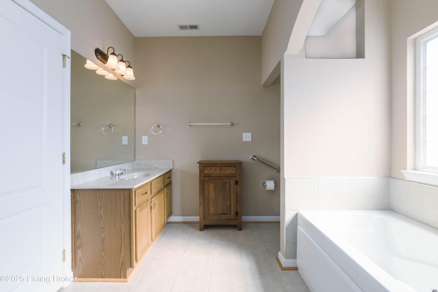 bathroom featuring baseboards, visible vents, tile patterned floors, vanity, and a bath