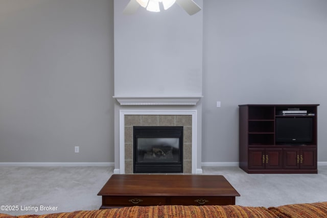 unfurnished living room featuring carpet, a fireplace, baseboards, and ceiling fan