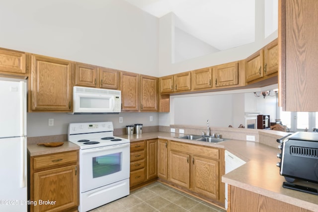 kitchen featuring white appliances, a toaster, light countertops, high vaulted ceiling, and a sink