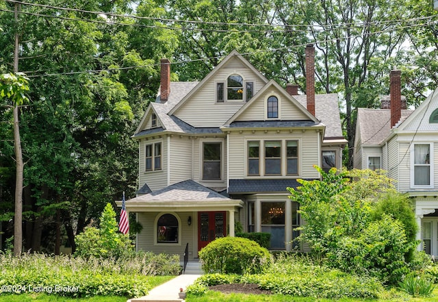 view of front of house with covered porch and a shingled roof