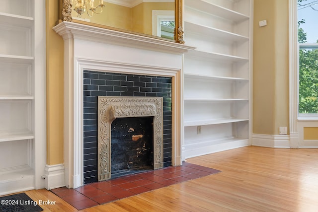 unfurnished living room featuring dark wood-type flooring, a fireplace, and built in features