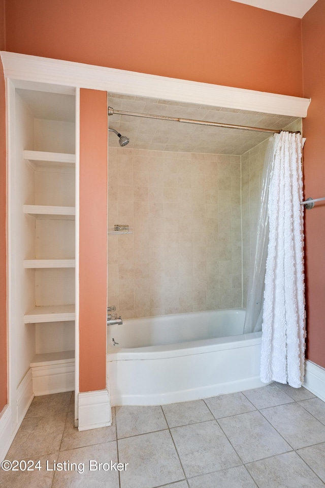 bathroom featuring shower / tub combo, tile patterned flooring, built in shelves, and baseboards