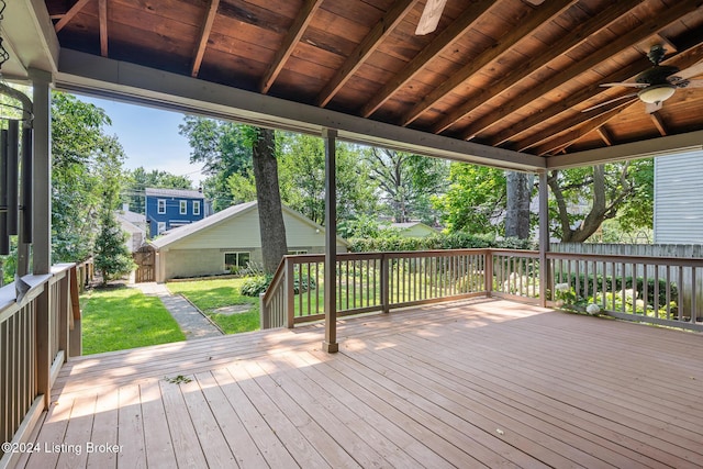 deck with ceiling fan, a fenced backyard, and a yard