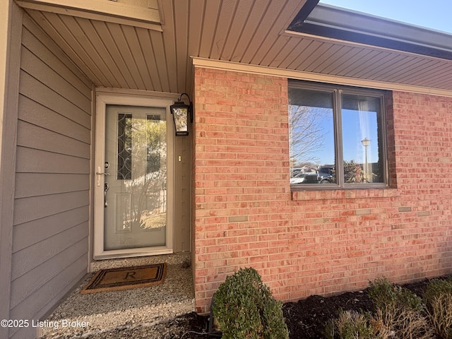 property entrance featuring brick siding