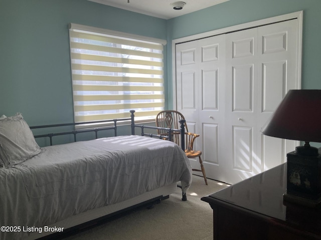 carpeted bedroom with a closet