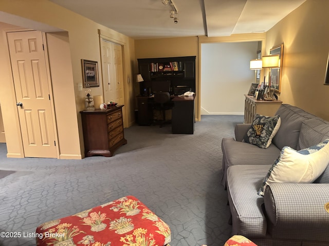 living room with carpet flooring, rail lighting, and baseboards