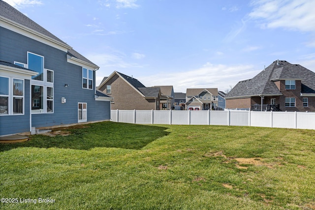 view of yard featuring a residential view and fence