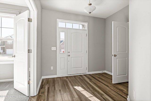 entrance foyer with wood finished floors, visible vents, and baseboards