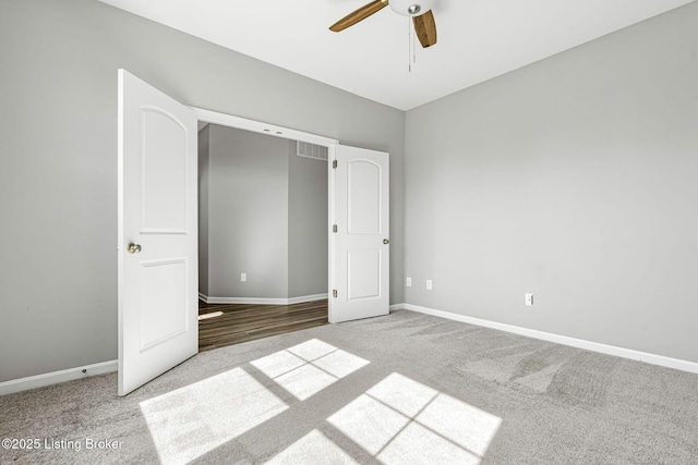 unfurnished bedroom featuring carpet floors, ceiling fan, and baseboards