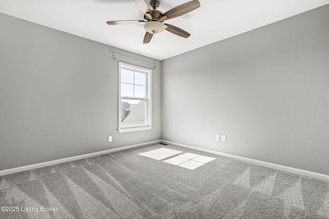 empty room featuring ceiling fan, carpet flooring, and baseboards