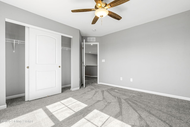 unfurnished bedroom featuring baseboards, visible vents, and carpet flooring