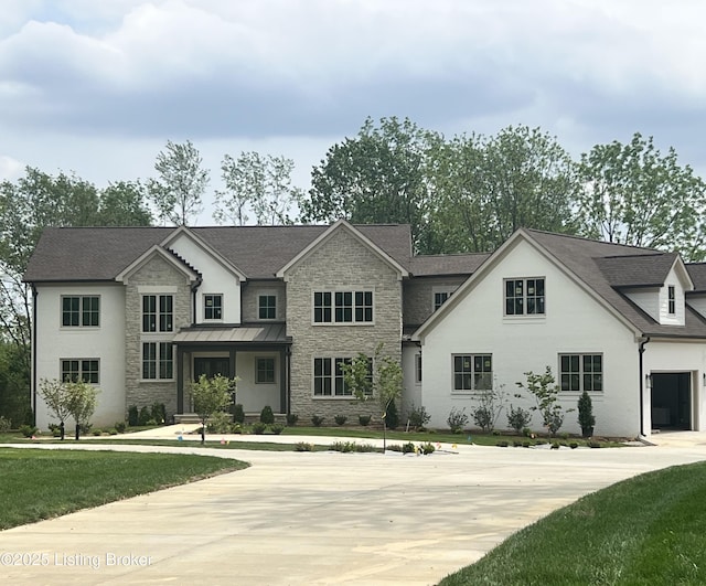 view of front of home with stone siding, a front lawn, and a shingled roof