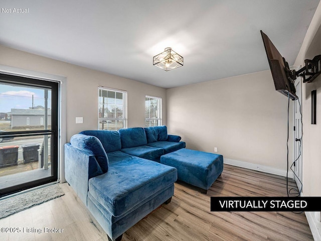 living room with baseboards and wood finished floors