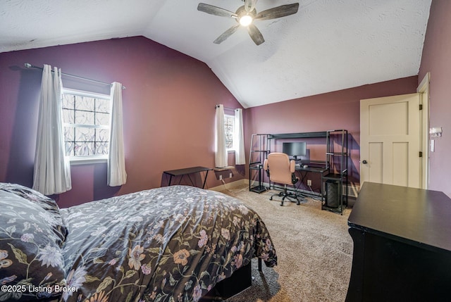 bedroom featuring carpet, multiple windows, vaulted ceiling, and a textured ceiling