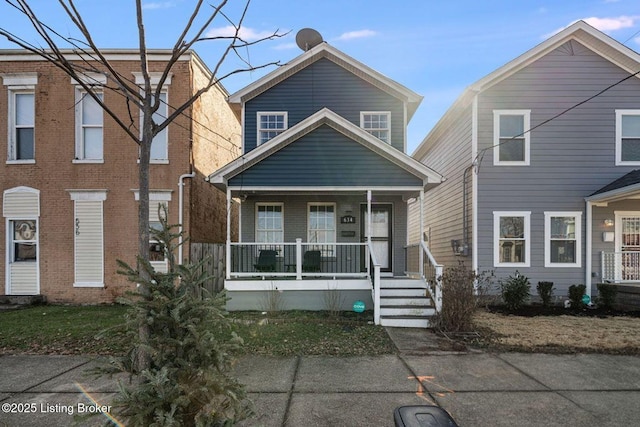 view of front of house with covered porch and brick siding